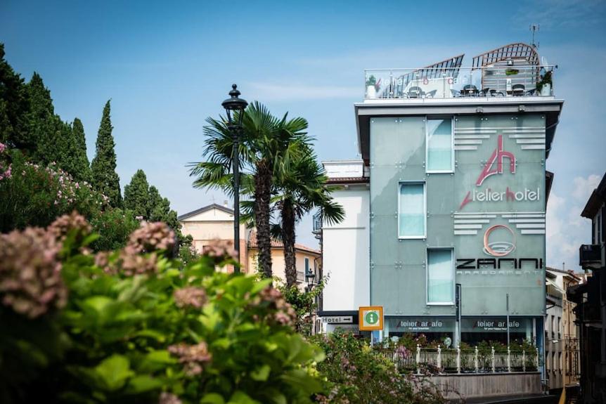 un bâtiment avec une enseigne sur le côté dans l'établissement Happy Hotel Atelier Gardone Riviera Centro & Spa, à Gardone Riviera 36 autres photos