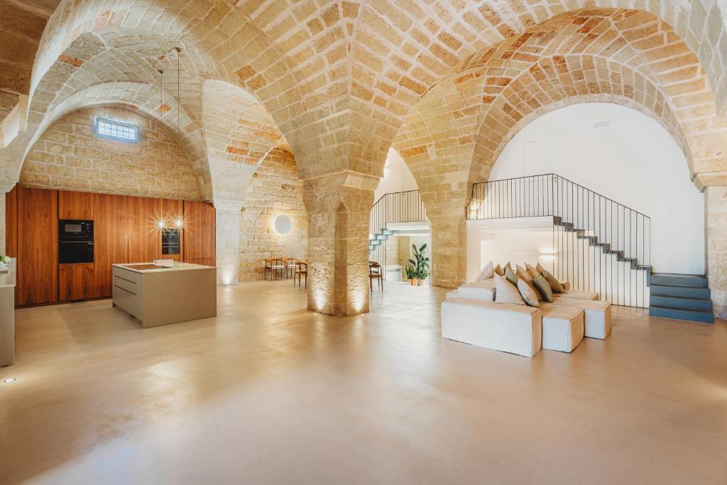 Cette grande chambre est dotée d'un mur en briques. dans l'établissement Frantoio Luxury Villa by HDSalento, à Melendugno