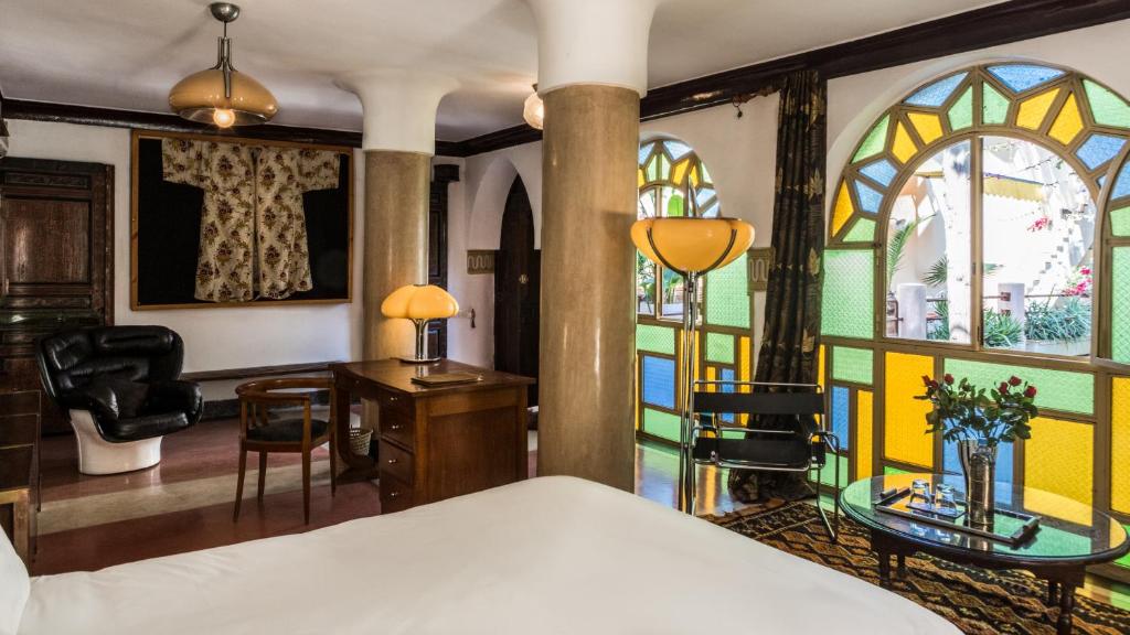 une chambre avec un lit et des vitraux dans l'établissement Riad Malika, à Marrakech