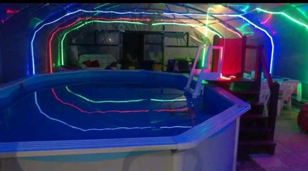 une chambre avec une piscine avec des néons dans l'établissement Bell tent one of three to rent fully equipped private equipped kitchen tents too, à Saint-Michel-de-Montjoie