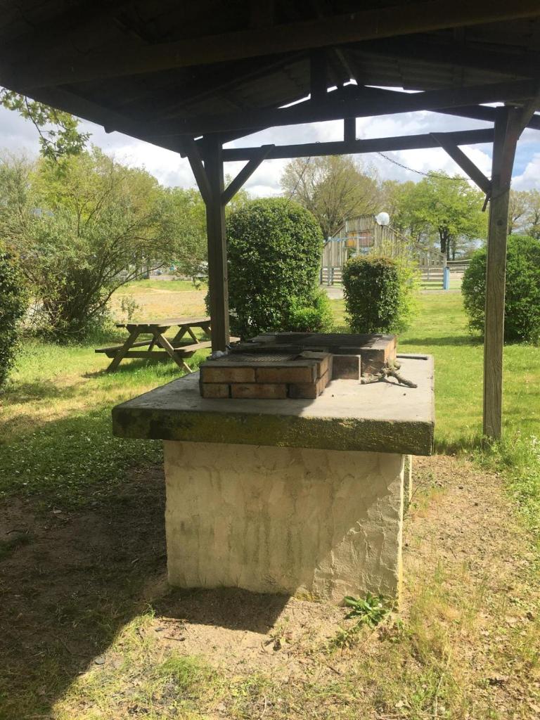 - une table de pique-nique avec des bûches au-dessus dans un parc dans l'établissement PuyduFou MH F4 FULL CONFORT 6personnes 220FS, à La Boissière-de-Montaigu