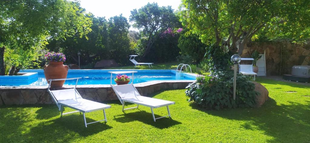 une cour avec des chaises et une piscine dans l'établissement GreenVilla, à La Caletta