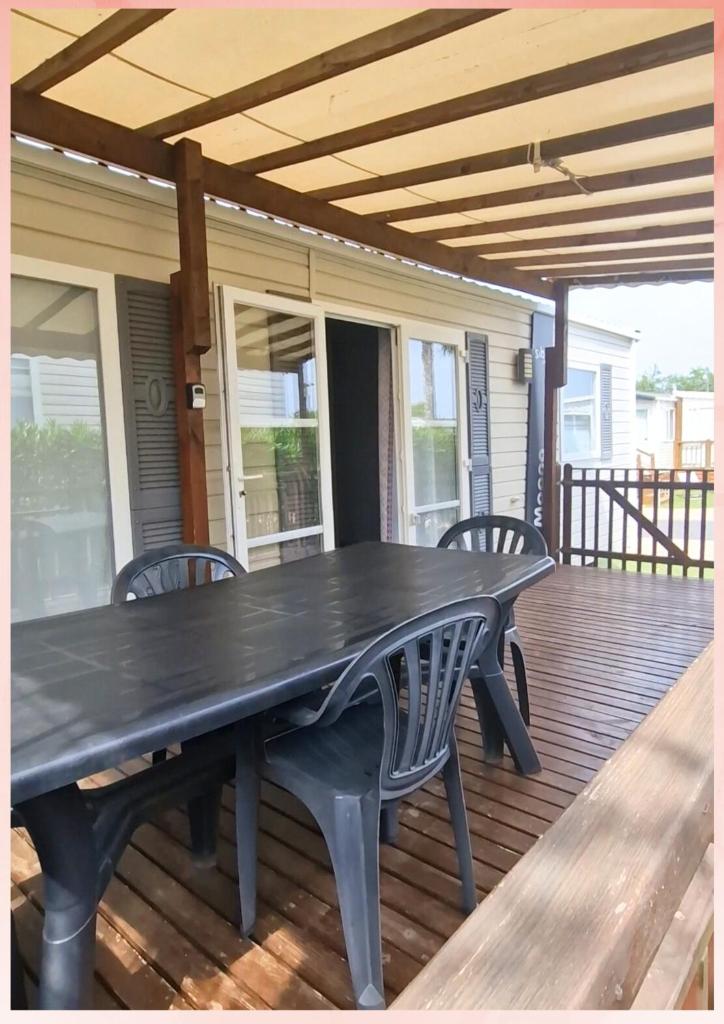 - une table de pique-nique sur le pont d'une maison dans l'établissement Les Sables du Midi, Agréable Mobilhome 6 personnes Valras Plage, à Valras-Plage
