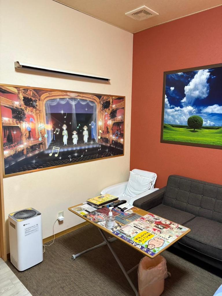 un salon avec un canapé et une table dans l'établissement ホテル キラリ, à Tottori