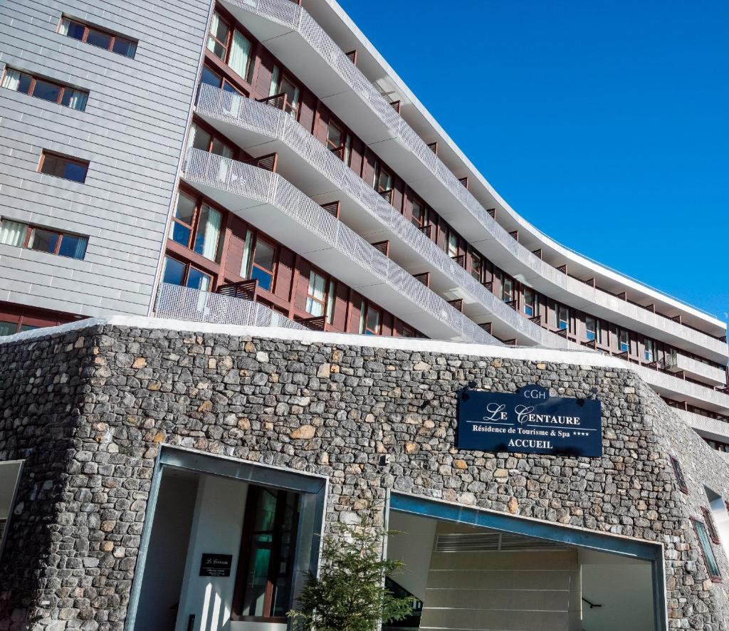 un bâtiment avec une enseigne devant lui dans l'établissement CGH Résidence Boutique Le Centaure, à Flaine