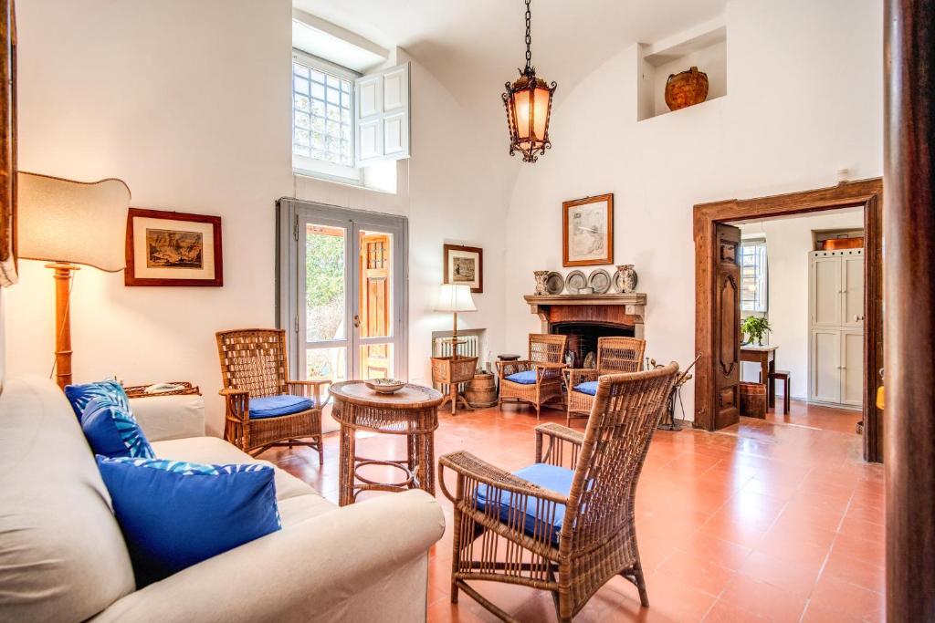 un salon avec un canapé et des chaises dans l'établissement Villa Monticello, private pool and timeless beauty, à Massa Lubrense