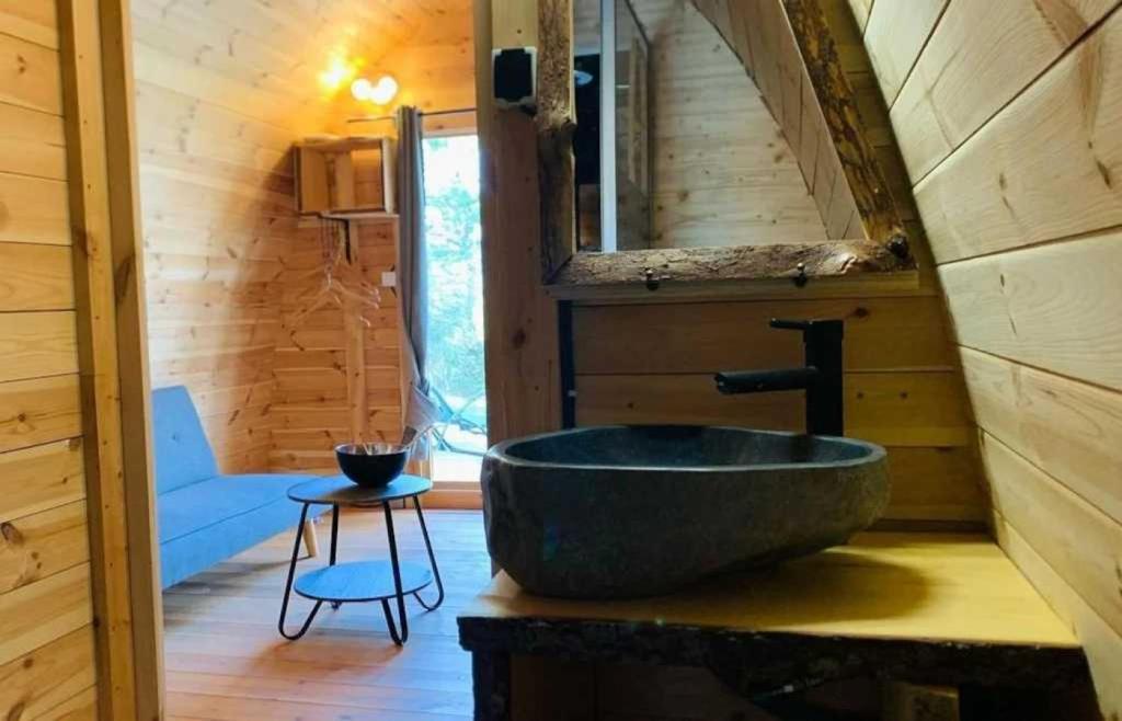 une salle de bain avec un lavabo dans une cabane en rondins dans l'établissement Camping 4 étoiles - Piscine - ccbacgb, à Rosans
