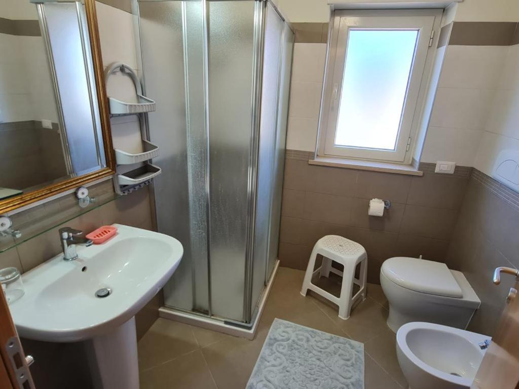 une salle de bain avec un lavabo, une douche et des toilettes dans l'établissement Villa Brenda, à Pizzo