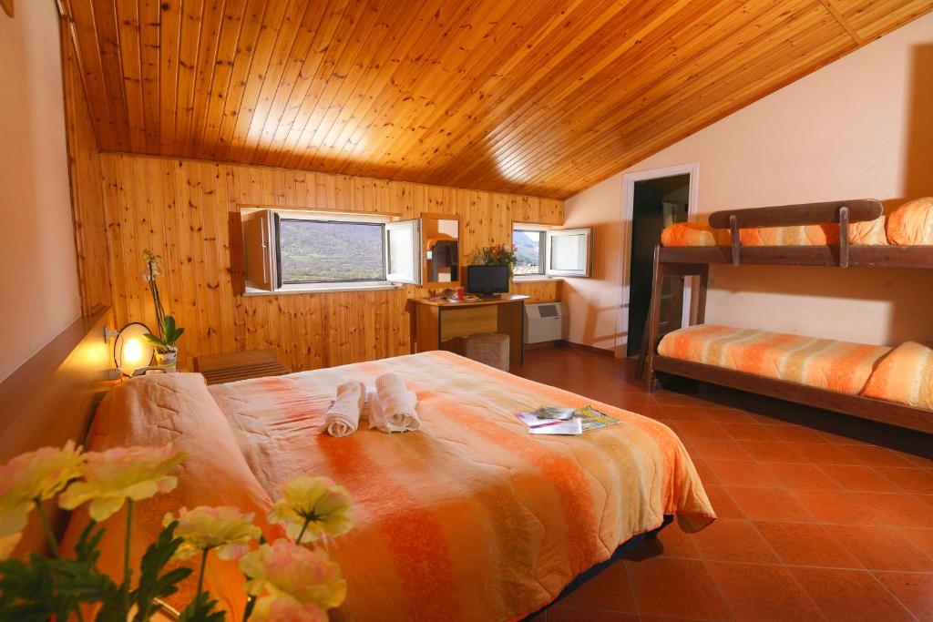 une chambre avec un lit et deux lits superposés dans l'établissement HOTEL HOLIDAYS a Barrea - Natura, Relax e Benessere nel Parco d'Abruzzo, à Barrea