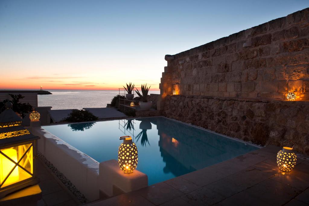 une villa avec une piscine au coucher du soleil dans l'établissement Hotel Don Ferrante, à Monopoli