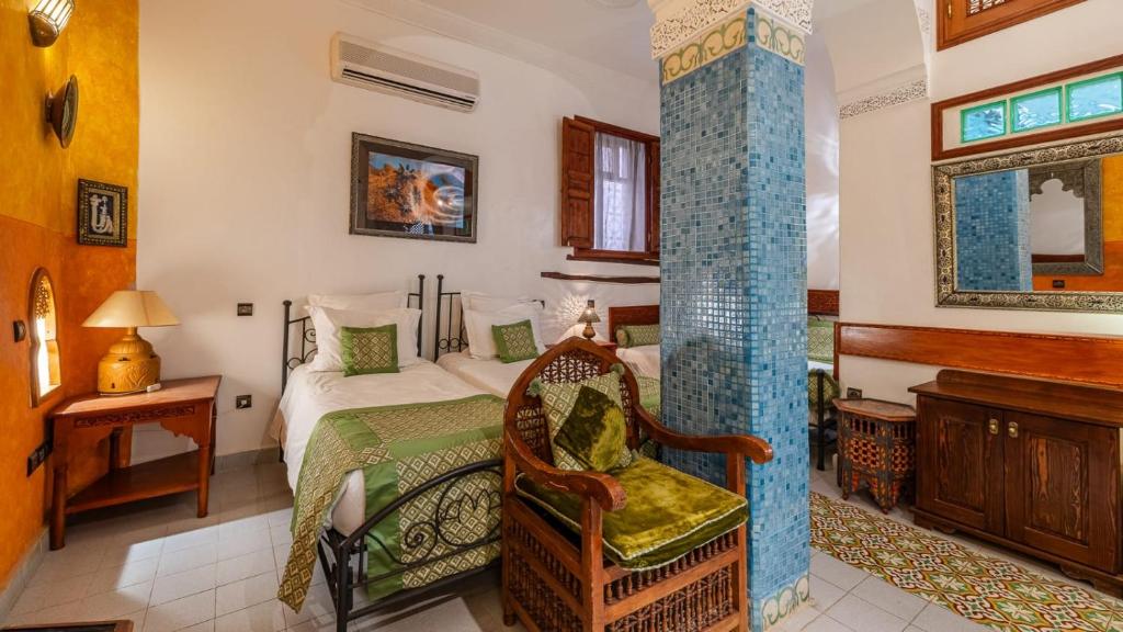 une chambre avec un lit et une chaise dans une pièce dans l'établissement Riad Maison Arabo-Andalouse, à Marrakech 37 autres photos