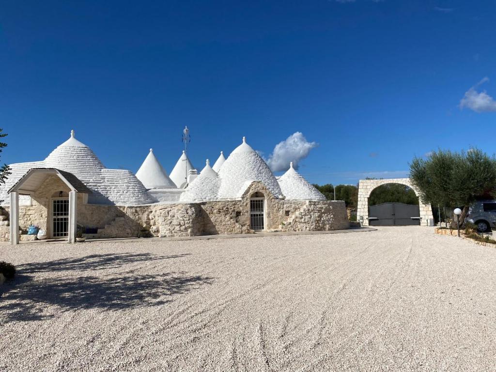 Un bâtiment avec des dômes blancs en haut dans l'établissement Trulli LENUCCIA villa, à Ceglie Messapica