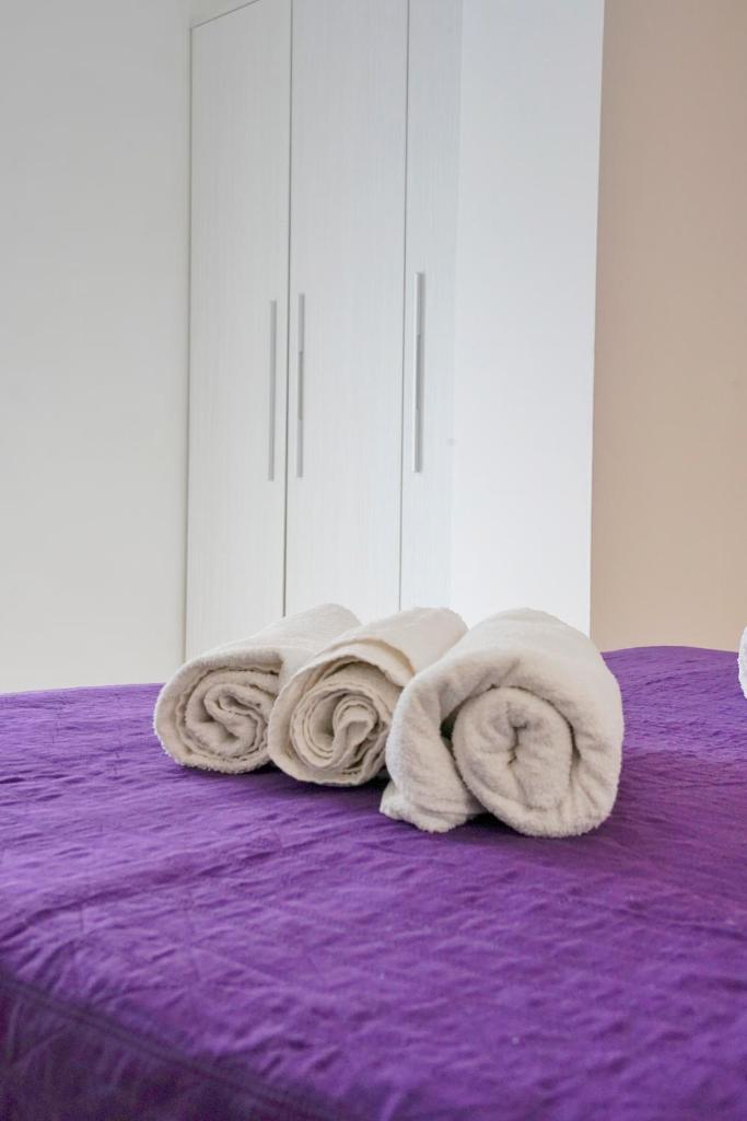 une pile de serviettes posée sur un lit dans l'établissement Hotel Malibù Mare, à Rimini