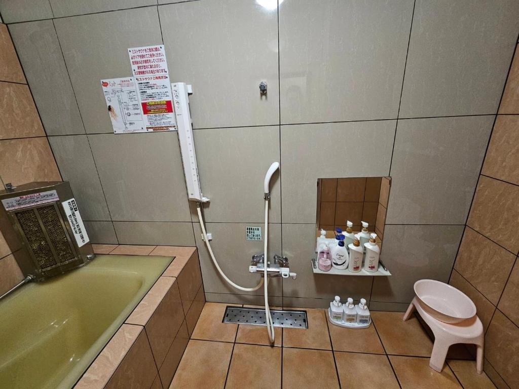 une salle de bain avec une baignoire, des toilettes et un lavabo dans l'établissement ホテル あぱっち, à Tuyama