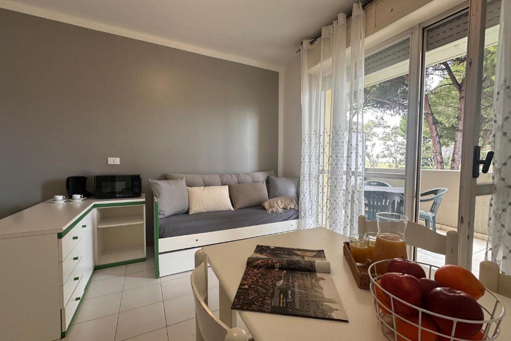 une cuisine et un salon avec un canapé et une table dans l'établissement Residenza Pierre & Vacances Luni Mare, à Luni