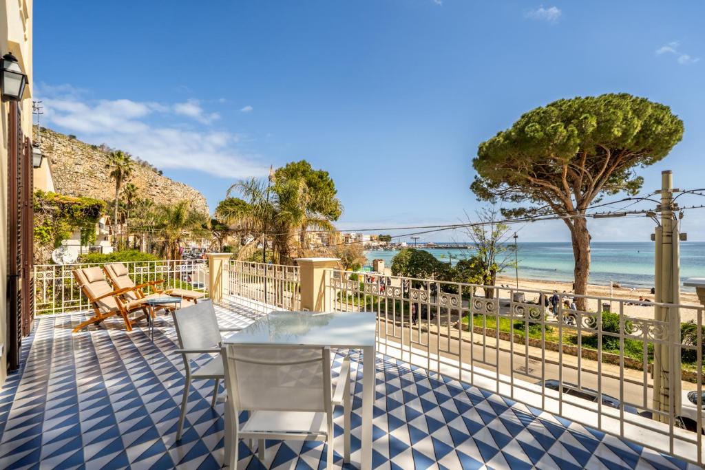 une terrasse avec une table et des chaises et la plage dans l'établissement Villa Hercules Pool & Beach, à Palerme