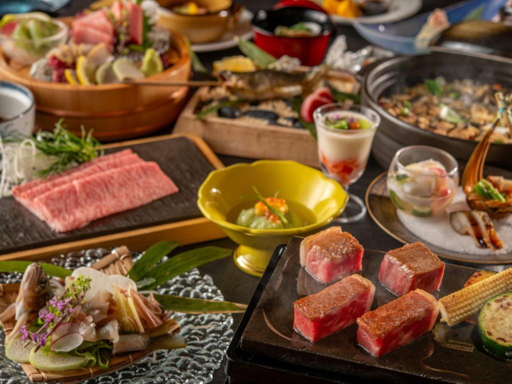 une table contenant de nombreux types de denrées alimentaires différents dans l'établissement KAMENOI HOTEL Kitsuregawa, à Sakura 37 autres photos