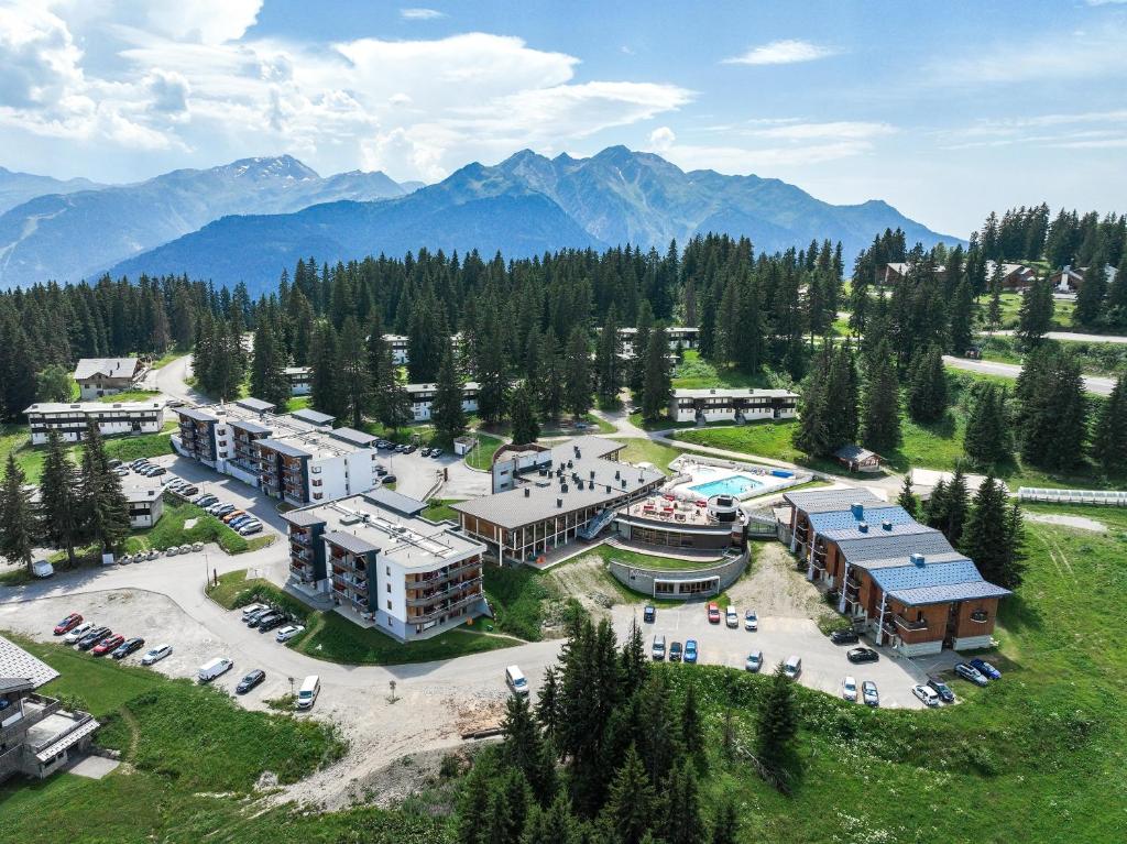 une vue aérienne d'une station balnéaire avec des montagnes en arrière-plan dans l'établissement Belambra Clubs Les Saisies - Les Embrunes - Ski pass included, à Villard-sur-Doron