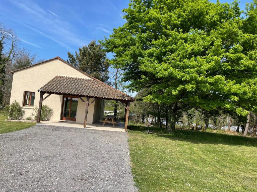 - un bâtiment avec un pavillon à côté d'un arbre dans l'établissement Séjour à la campagne dans un domaine de 4 gîtes, à Boulazac