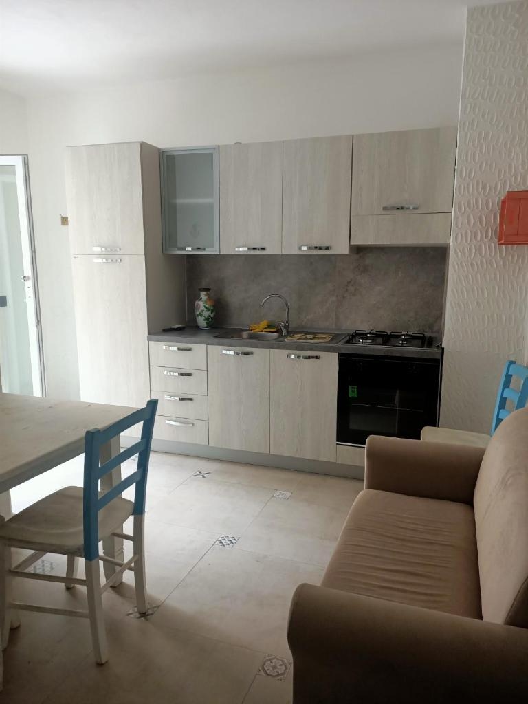 - une cuisine avec un canapé et une table dans une chambre dans l'établissement RESINDENZE Donna Sabella, à Santa Flavia