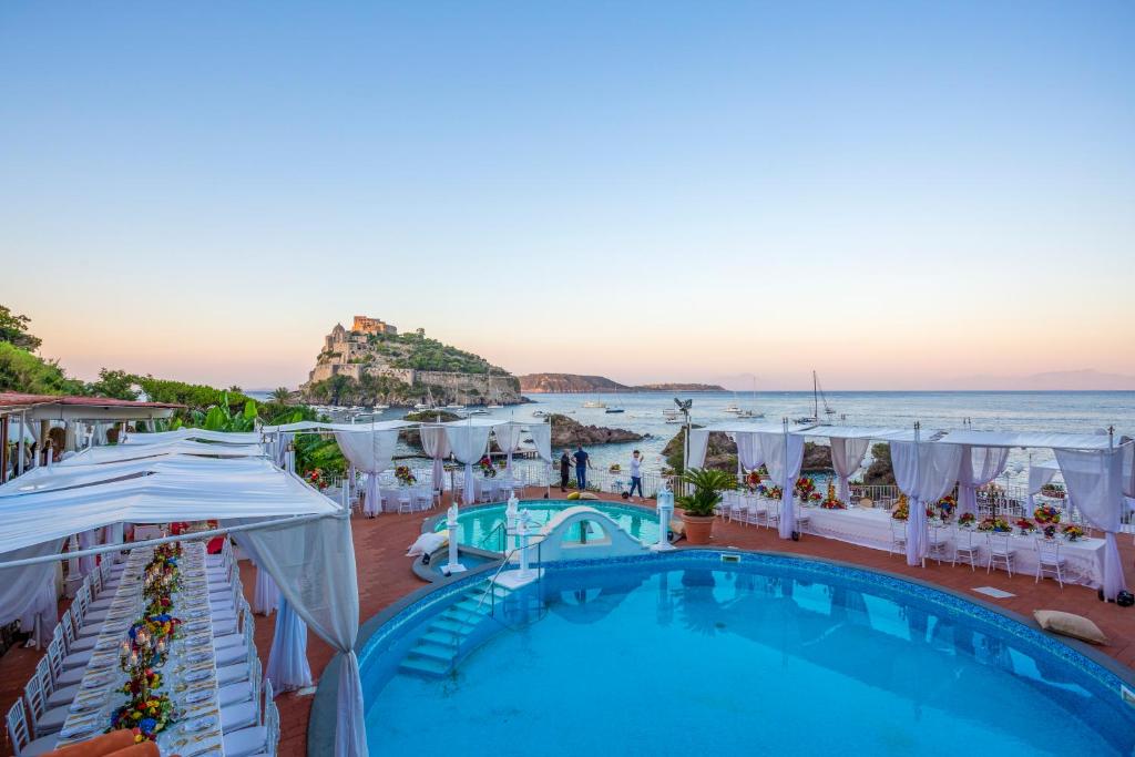 - une vue sur la piscine d'un complexe avec l'océan dans l'établissement Strand Hotel Delfini, à Ischia