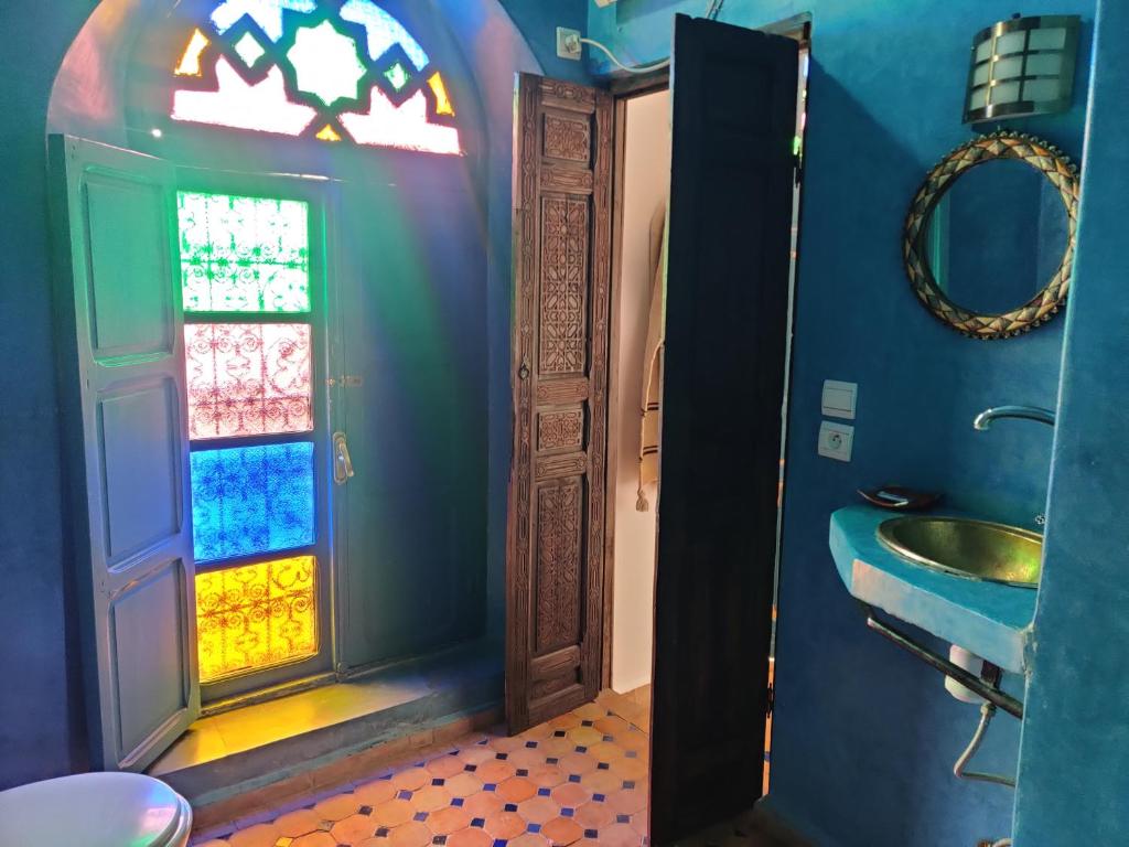 La salle de bains est pourvue d'un lavabo et d'un vitrail. dans l'établissement Riad Menthe Et Citron, à Meknès
