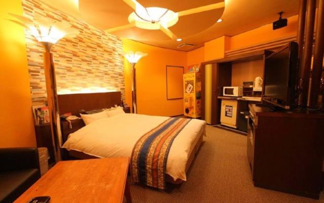 une chambre d'hôtel avec un lit et une télévision dans l'établissement hotel surfrider, à Wada-shinden