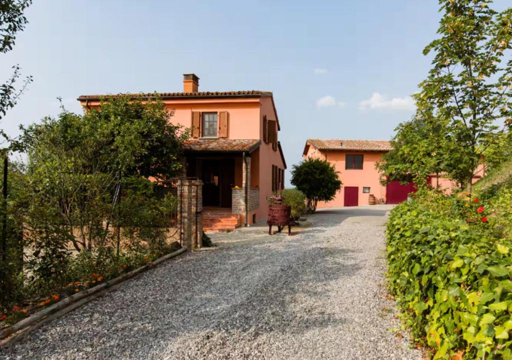 une maison avec une route en gravier devant elle dans l'établissement Villa Teresa - Villa & Piscina immersi nel vigneto!, à Montecalvo Versiggia