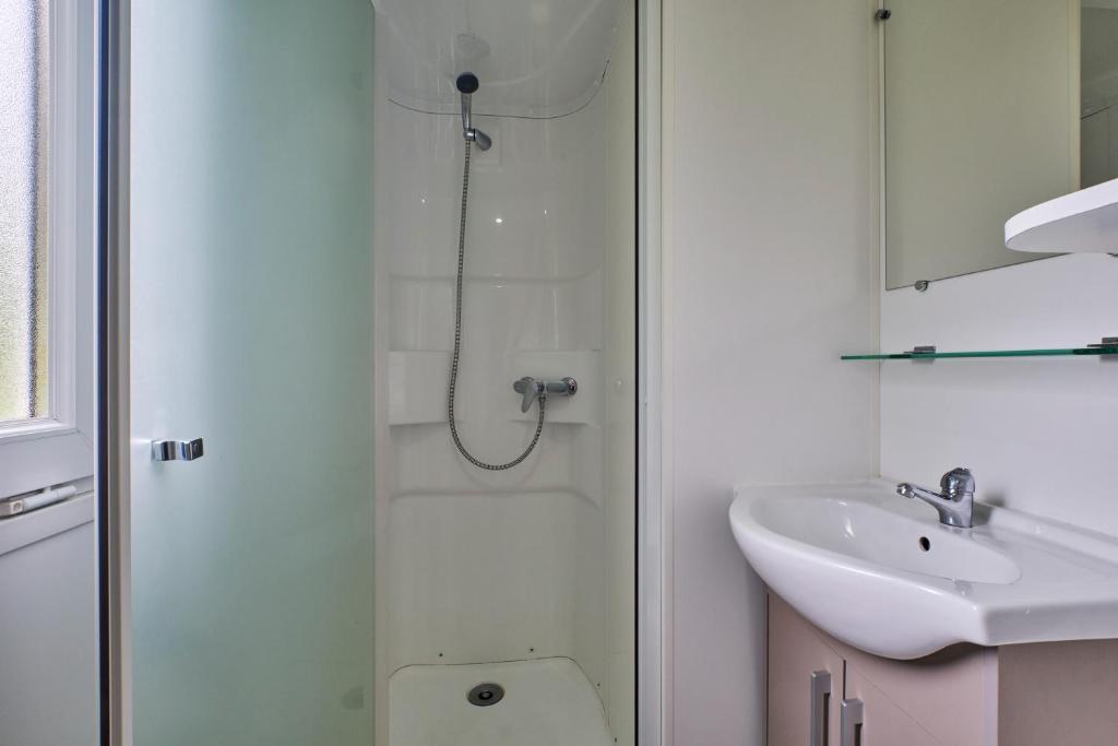 une salle de bain avec une douche, des toilettes et un lavabo dans l'établissement Mobil Home 6 personnes 206, à Mens