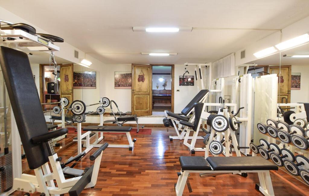 - une salle de sport avec des tapis de course et des machines dans l'établissement Luxury Villa with pool by Varental, à Melezzole
