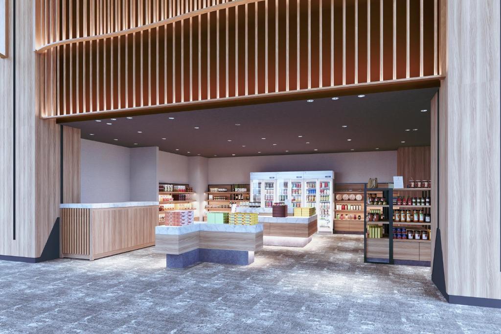 une bibliothèque avec des étagères et une librairie dans l'établissement KAMENOI HOTEL Yaizu, à Yaizu