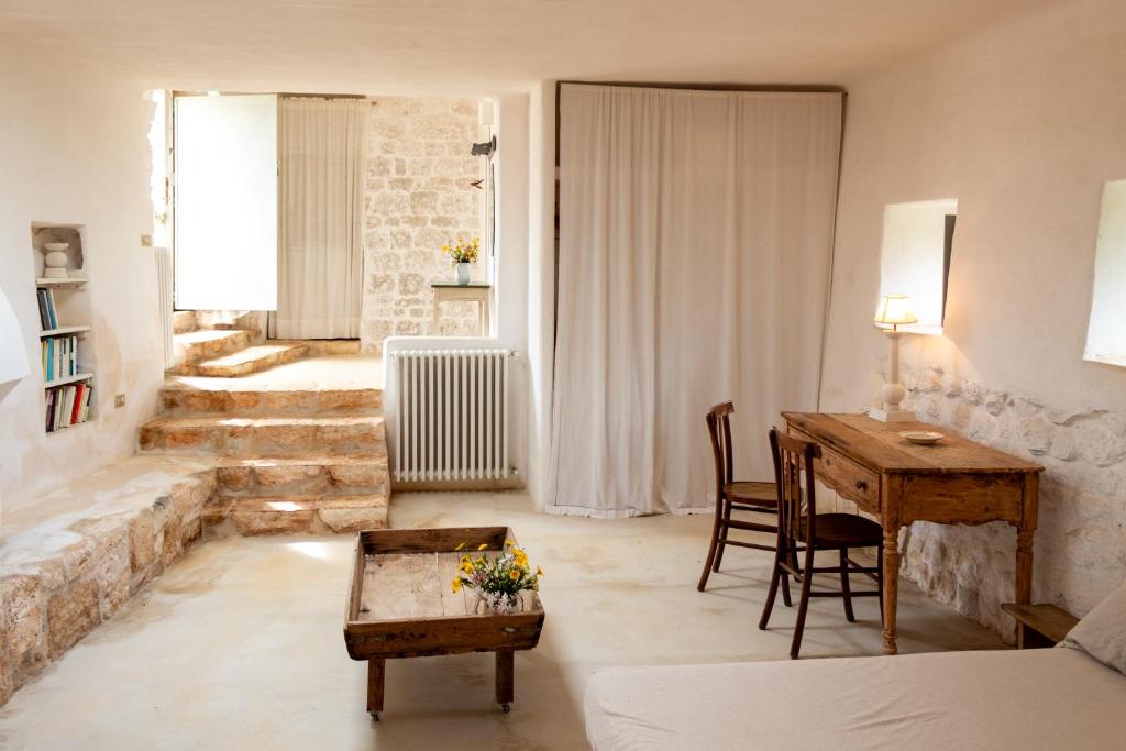 un salon avec un bureau et une table dans l'établissement Accademia degli Inquieti - Casina Gargiulo, à Ceglie Messapica