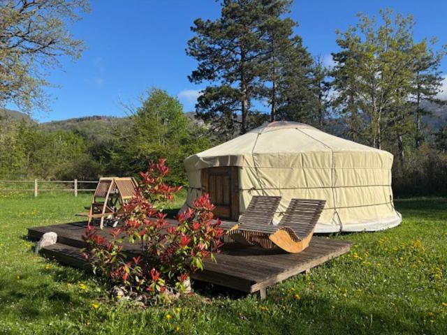 une yourte avec deux chaises et une table dans l'établissement Yourte mongole, à Champfromier