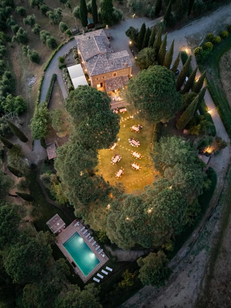 Cette chambre offre une vue sur une demeure de caractère dotée d'une piscine et d'arbres. dans l'établissement Torre Collevento Luxury Villa, à Orvieto