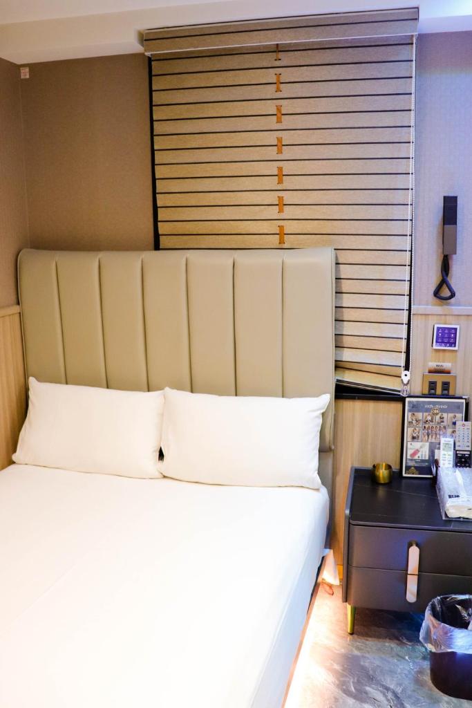 une chambre avec un grand lit blanc et une fenêtre dans l'établissement Ikebukuro Montana, à Tokyo 32 autres photos