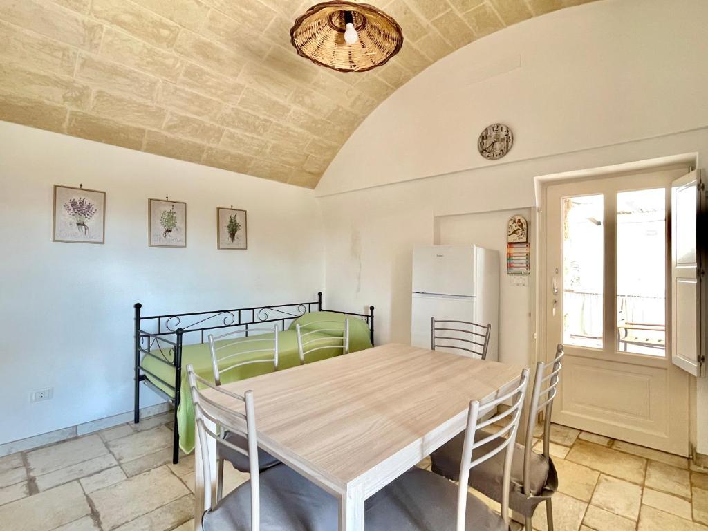 - une salle à manger avec une table et des lits superposés dans l'établissement Trullo vista mare con idromassaggio, à Marina San Gregorio