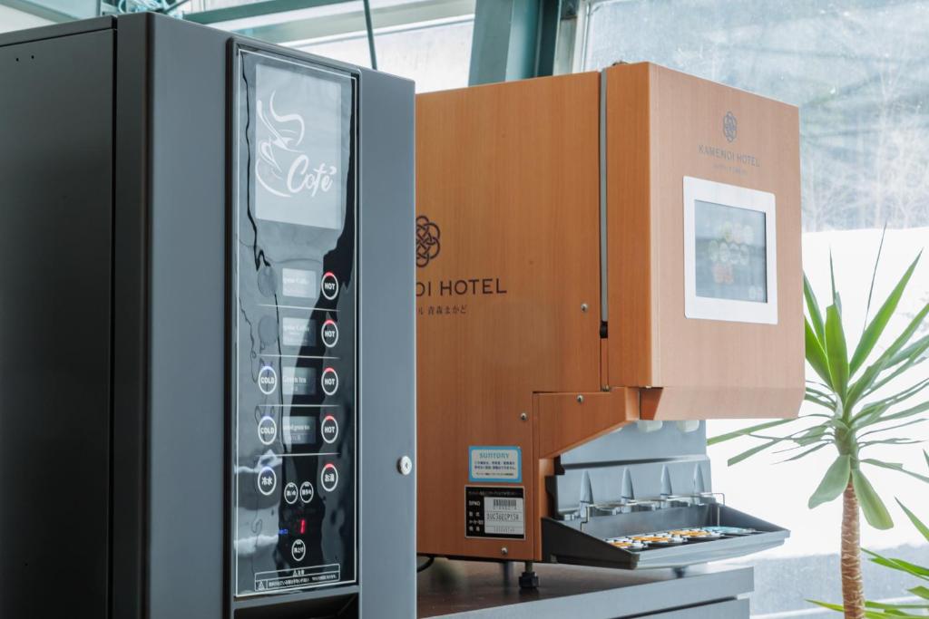 une machine à café est à côté d'une boîte dans l'établissement KAMENOI HOTEL Aomori Makado, à Noheji