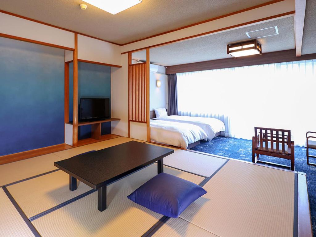 une chambre avec un lit, une table et une télévision dans l'établissement Ooedo Onsen Monogatari Premium Kinugawa Kanko Hotel, à Nikkō 39 autres photos