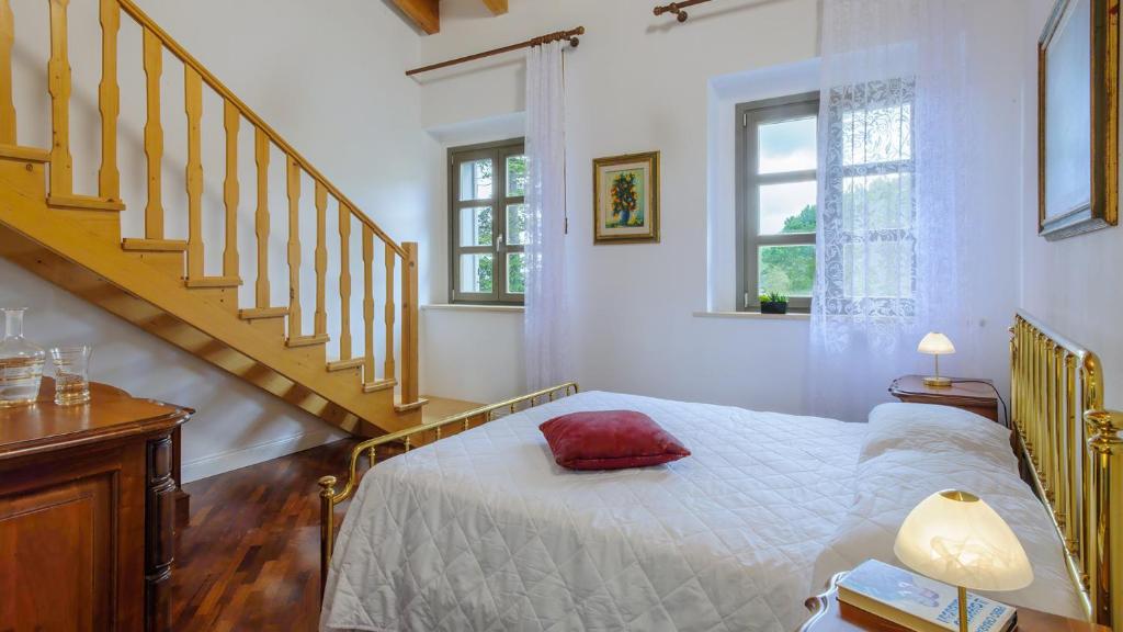 une chambre avec un lit avec un oreiller rouge dessus dans l'établissement VILLA CAPPELLETTI 16&2, Emma Villas, à Cese 36 autres photos