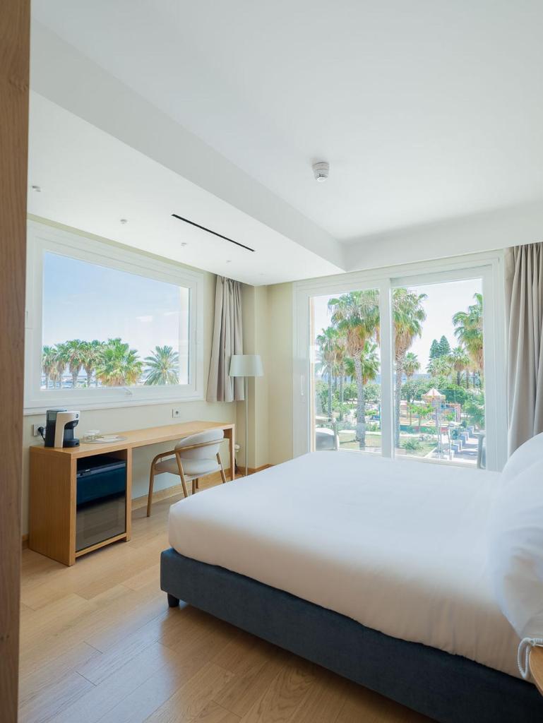 une chambre d'hôtel avec un grand lit et un bureau dans l'établissement San Vito Resort & Spa, à San Vito Lo Capo 26 autres photos