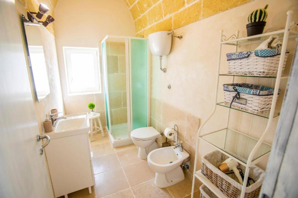 une salle de bain avec toilettes et lavabo dans l'établissement Villa La Pagghiara by Villa Plus, à Carovigno