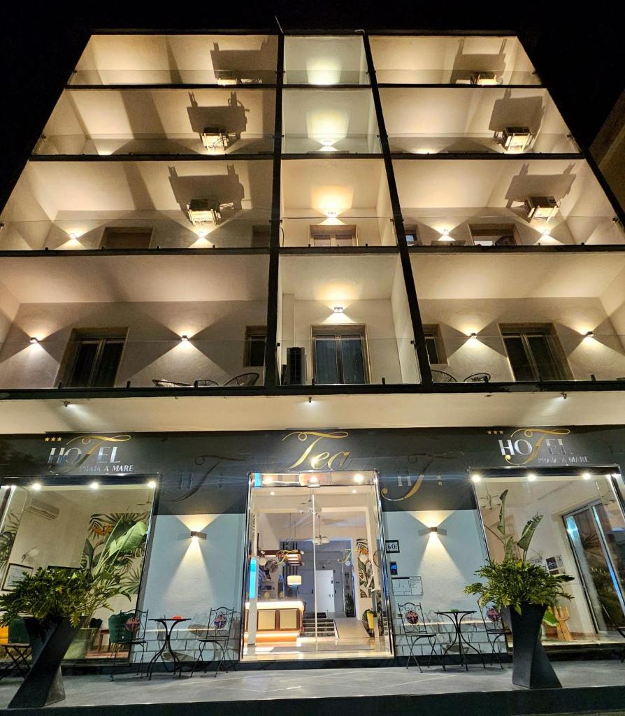 - un balcon avec des tables et des chaises dans l'établissement Hotel TEA - Praia a Mare, à Praia a Mare