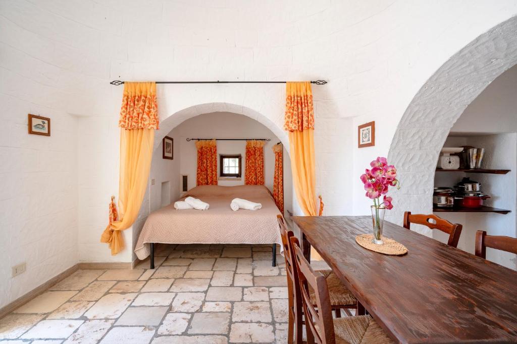 une chambre avec un lit et une table dans l'établissement Villa Trullo Ulivo with pool, à Carovigno
