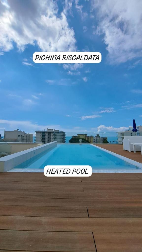 un panneau indiquant une piscine traitée sur le côté d'un bâtiment dans l'établissement Hotel Villa Eugenia - 3 Stelle Superior con Private SPA e Piscina, à Lido di Jesolo