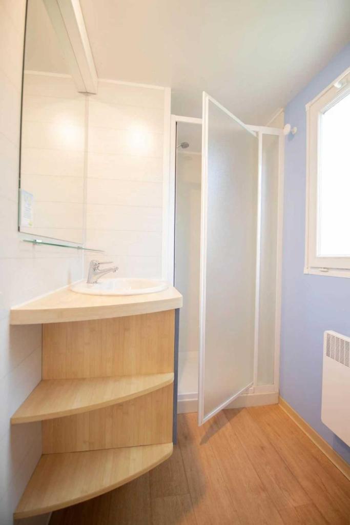 une salle de bain avec un lavabo et un miroir dans l'établissement Camping 4 étoiles - Piscine - ccbadea, à La Bastide-de-Sérou