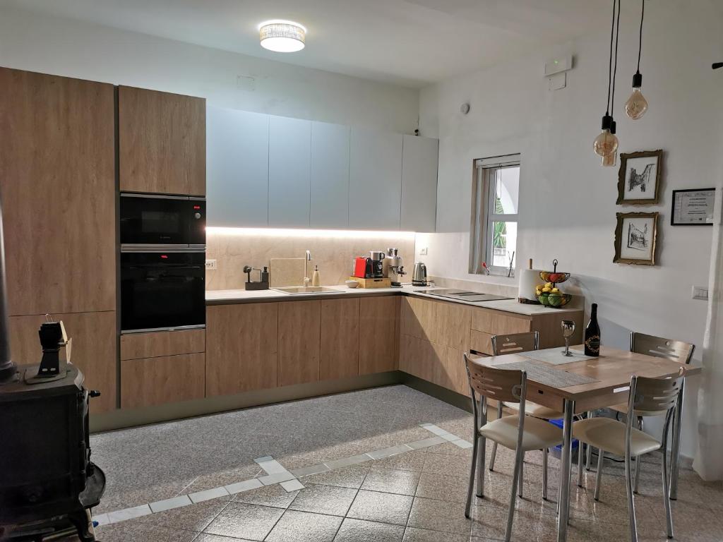 une cuisine avec une table, des chaises et un évier dans l'établissement Villa LVM San Vito Dei Normanni BR Italy, à San Vito dei Normanni