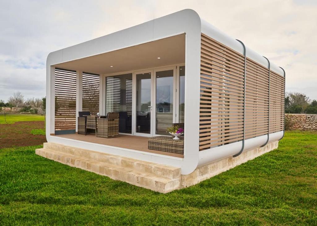 une maison moderne avec une terrasse avec des chaises et des fenêtres dans l'établissement Borgo Rosso Terra, à Gallipoli
