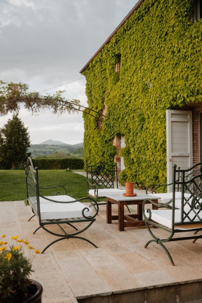 - un patio avec deux chaises et une table dans l'établissement Podere la Piscina acqua calda RestArt, à San Casciano dei Bagni