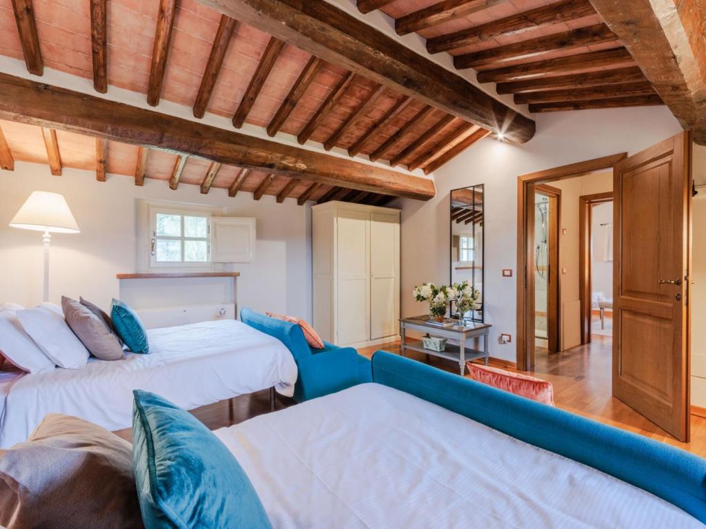 une chambre avec deux lits et un canapé dans l'établissement Villa in Monte San Quirico with Private Garden, à Cappella