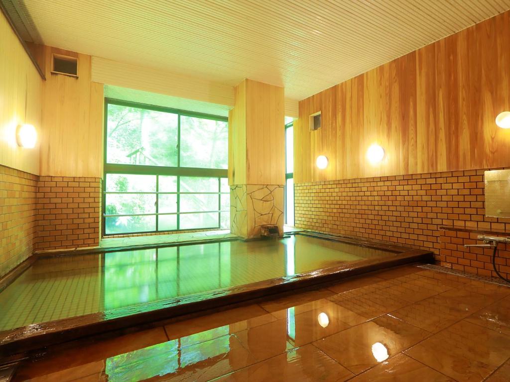 une pièce vide avec un sol en verre et une fenêtre dans l'établissement Taiyokan, à Minakami
